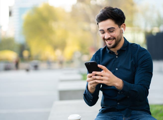 Image of man holding mobile phone