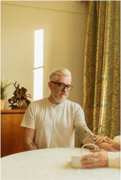 Old person checking his blood pressure using device